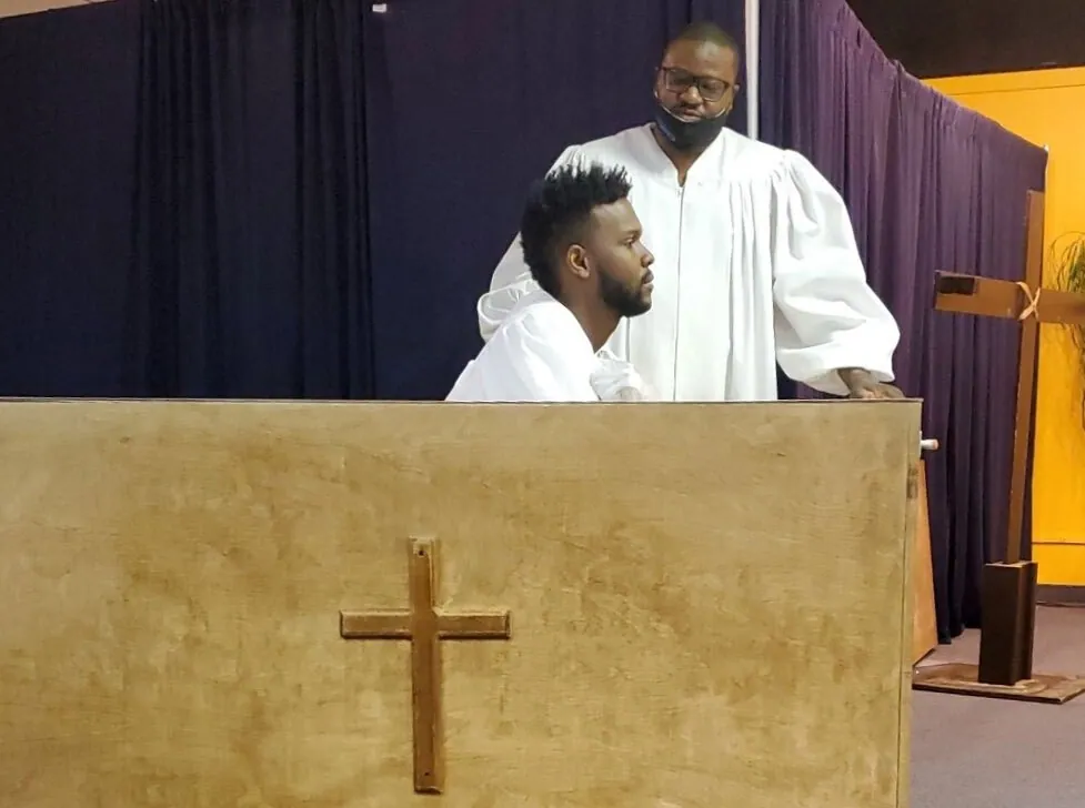 A baptism at Canton Christian Fellowship, two men in white robes at the baptistry