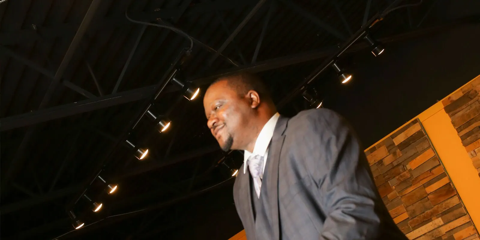 Pastor Washington under the stage lights at Canton Christian Fellowship